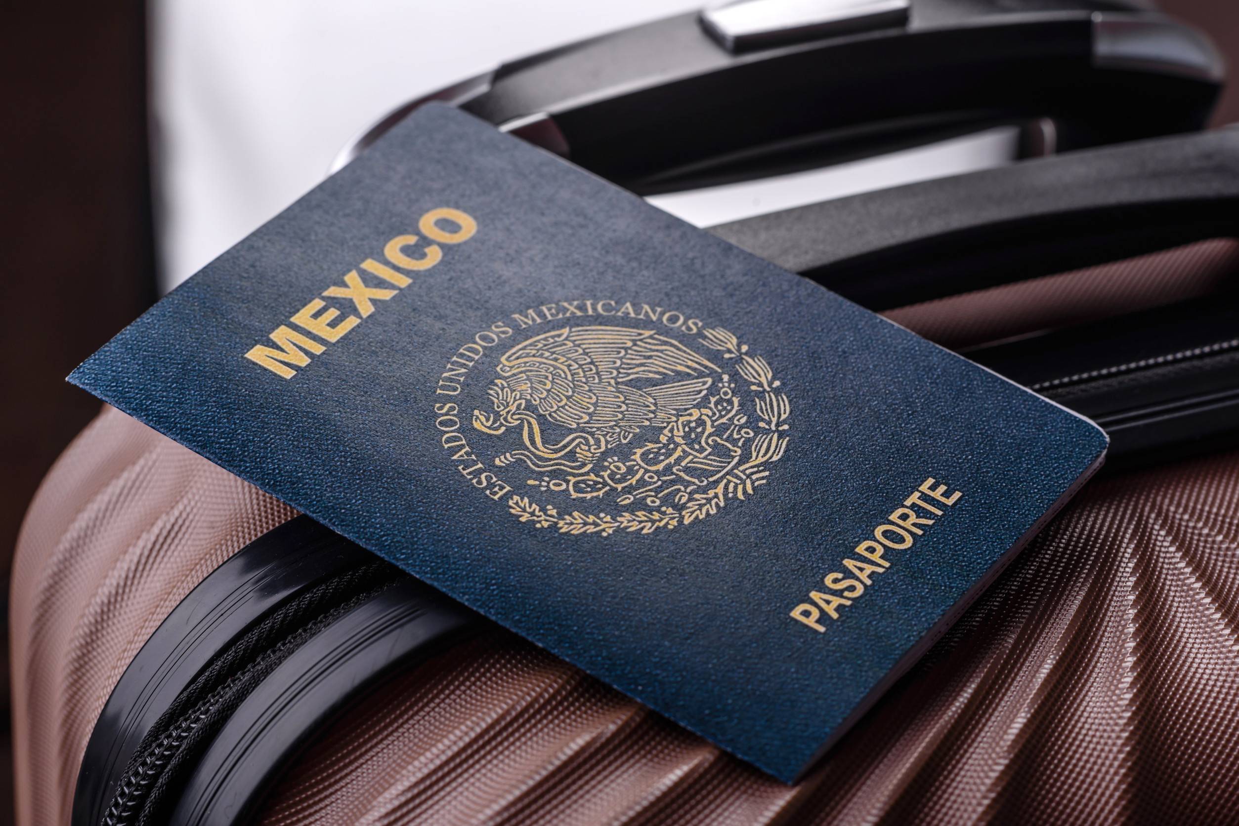 International passport of a citizen of Mexico on a suitcase departure from the airport
